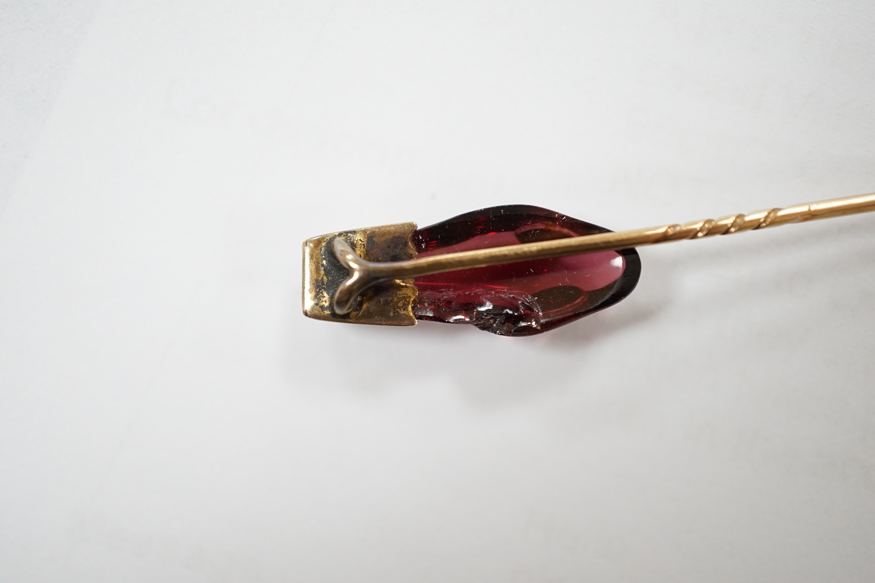 A late Victorian yellow metal, garnet and diamond set serpent head stick pin, 65mm, gross weight 2.9 grams (chip).